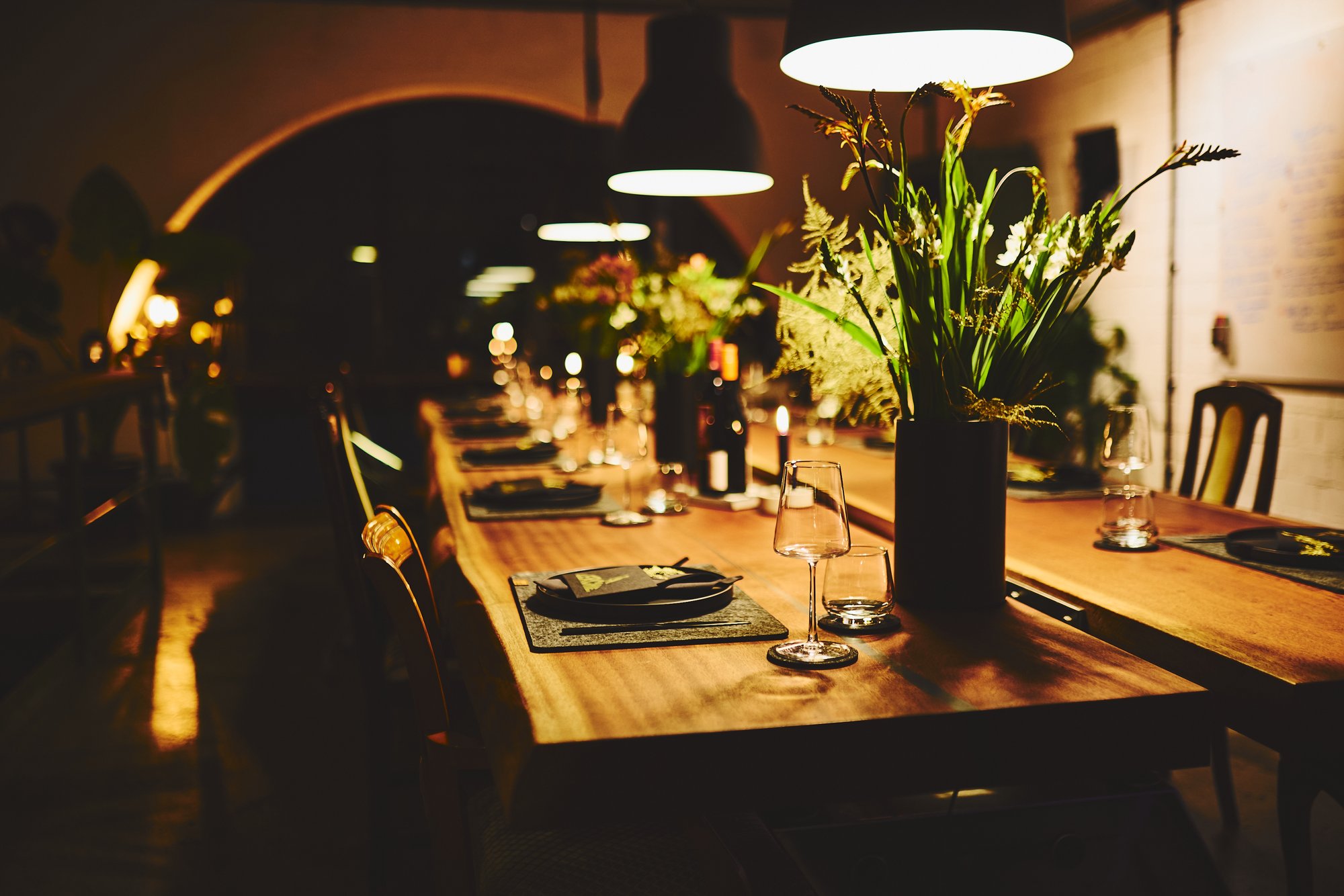 Festive table set with flowers, candles and glasses