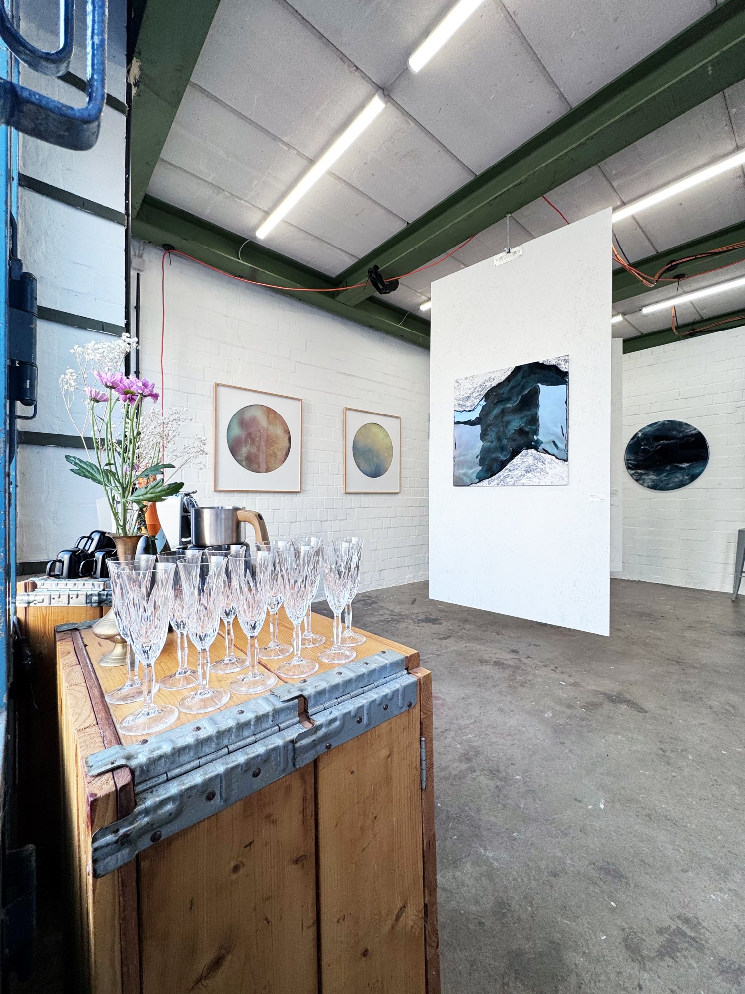 Pop-up gallery with artworks and a set table at the Lerche